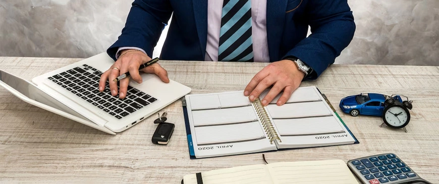 Financial Statements services showing accountant analyzing financial data at office desk